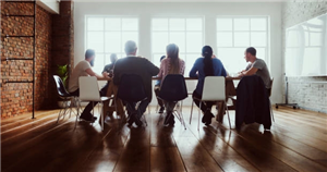 Professionals sat around a table